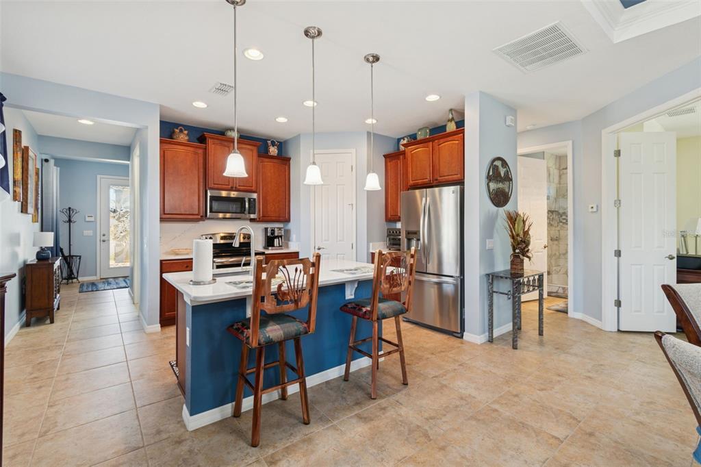 1689 Trabuco Canyon Court Kissimmee, FL 34759 - Photo 12 of 52 a kitchen with stainless steel appliances kitchen island granite countertop refrigerator and furniture