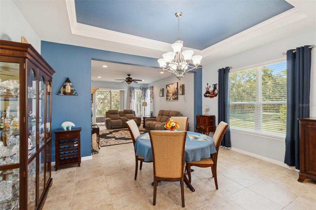 1689 Trabuco Canyon Court Kissimmee, FL 34759 - Photo 15 of 52 a dining room with furniture a chandelier and window