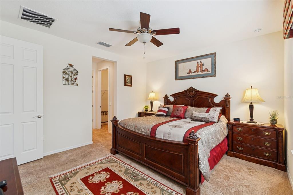 1689 Trabuco Canyon Court Kissimmee, FL 34759 - Photo 19 of 52 a bedroom with bed and wooden floor