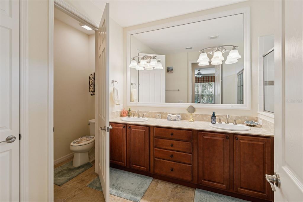 1689 Trabuco Canyon Court Kissimmee, FL 34759 - Photo 24 of 52 a bathroom with a double vanity sink and a mirror