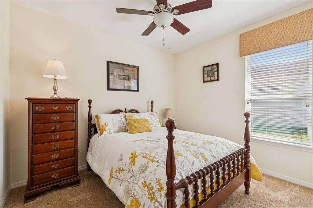 1689 Trabuco Canyon Court Kissimmee, FL 34759 - Photo 25 of 52 a bedroom with a bed and a lamp on the dresser