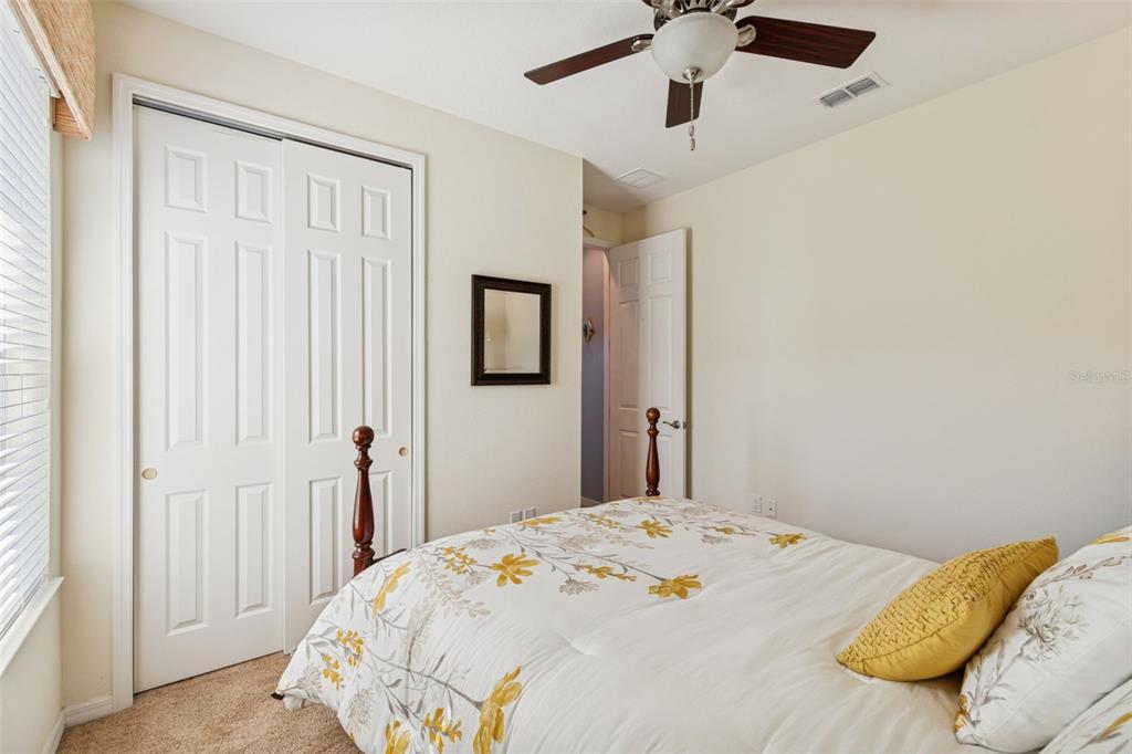 1689 Trabuco Canyon Court Kissimmee, FL 34759 - Photo 26 of 52 a bedroom with a bed and a chandelier
