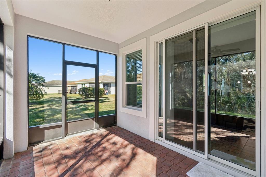 1689 Trabuco Canyon Court Kissimmee, FL 34759 - Photo 33 of 52 a bedroom with a balcony and a floor to ceiling window