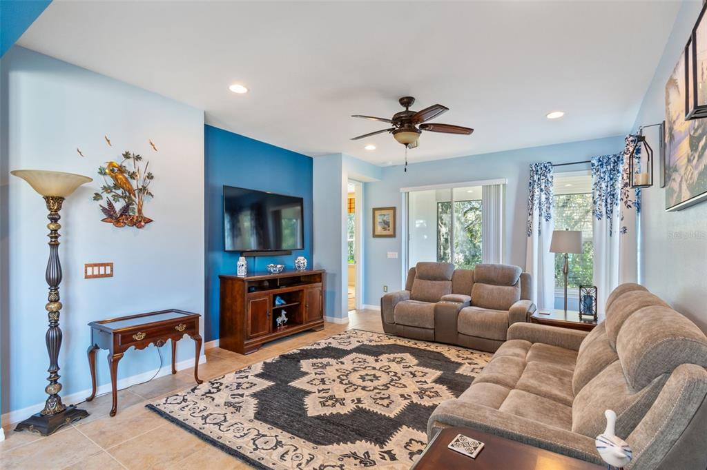 1689 Trabuco Canyon Court Kissimmee, FL 34759 - Photo 7 of 52 a living room with furniture and a flat screen tv