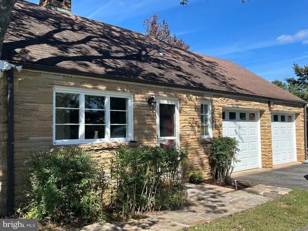 a spacious bedroom with a bed and a chair