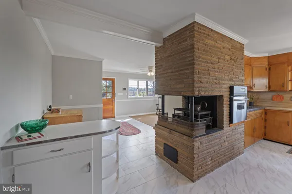 a living room with fireplace furniture and a large window