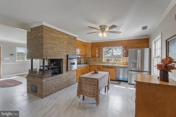 a living room with furniture and a kitchen view