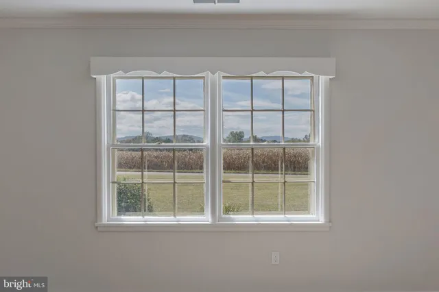 a view of a livingroom with an empty space and a window