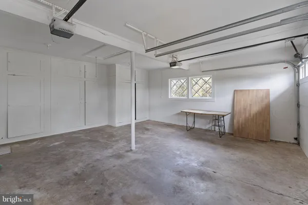 a front view of a house with a garden and yard