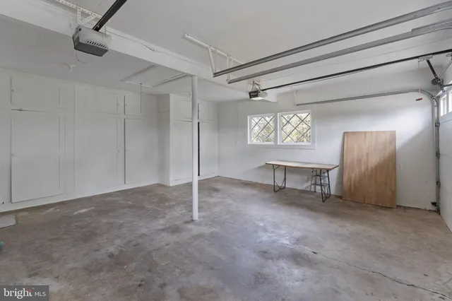 a front view of a house with a garden and yard