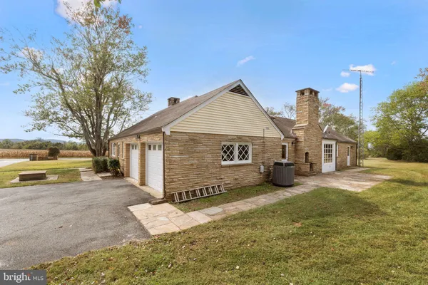 a view of a brick house with a yard