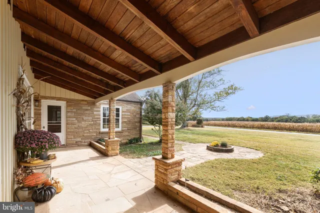 a view of a porch with a table and chairs