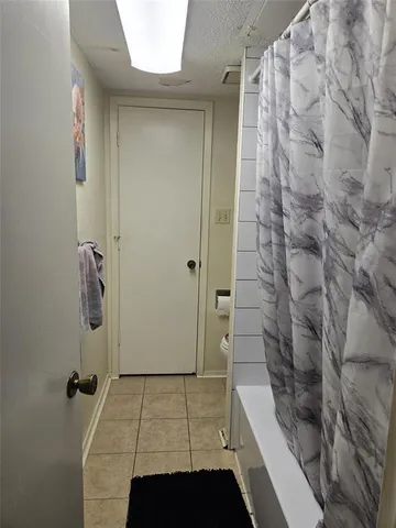 a bathroom with a bathtub and shower