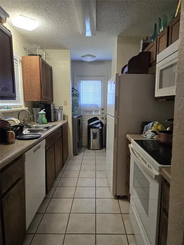 a kitchen with a sink a stove and a refrigerator