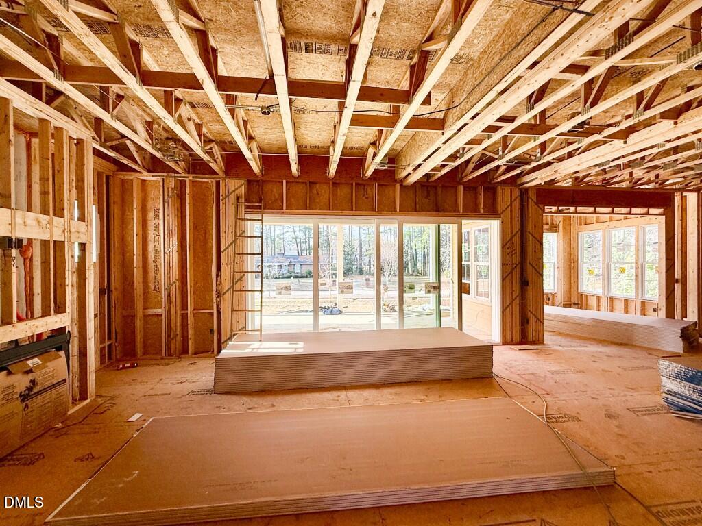 6513 Burnette Flower Way Raleigh, NC 27612 - Photo 6 of 22 a spacious bedroom with a large bed and large windows