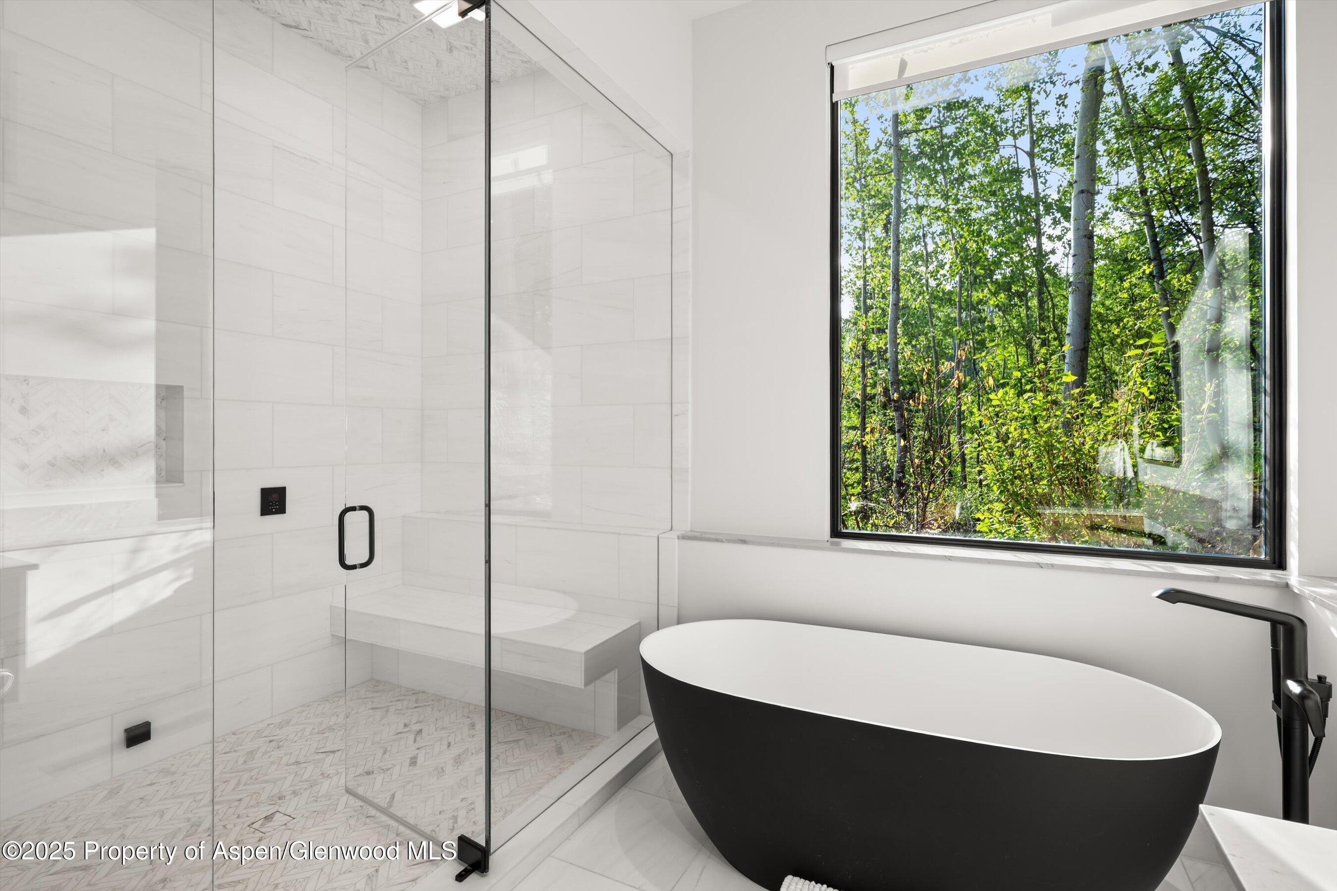 1234 Wood Road Snowmass Village, CO 81615 - Photo 42 of 66 a bathroom with a bathtub and window