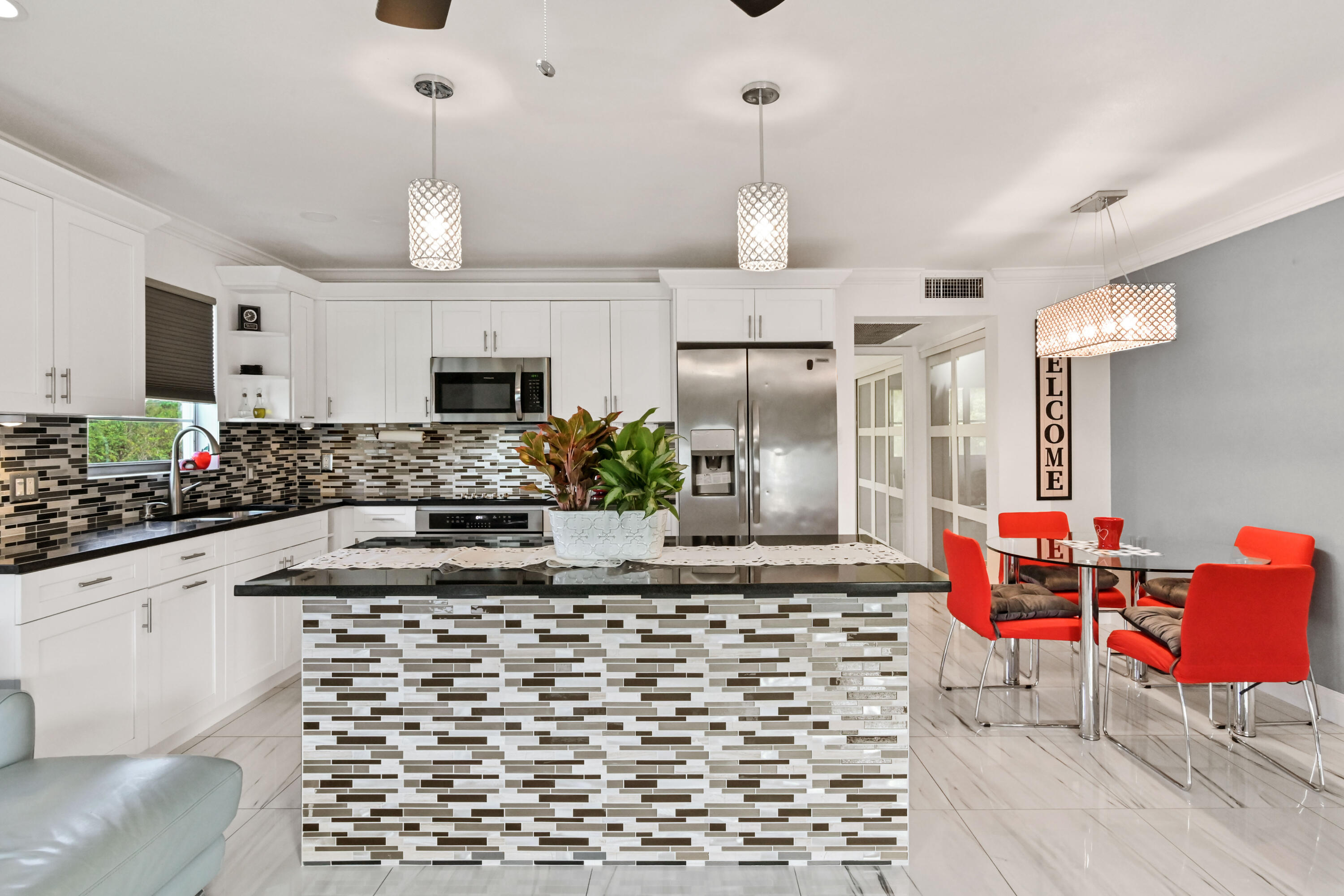 a kitchen with stainless steel appliances kitchen island granite countertop a sink and cabinets