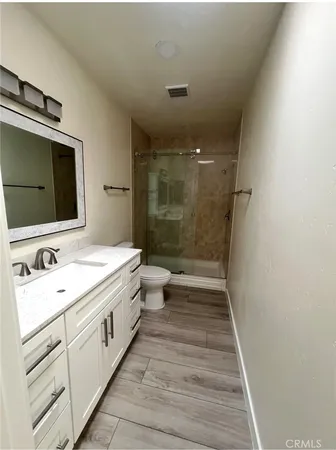 a bathroom with a double vanity sink toilet and shower