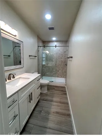 a bathroom with a sink a large mirror and a bathtub