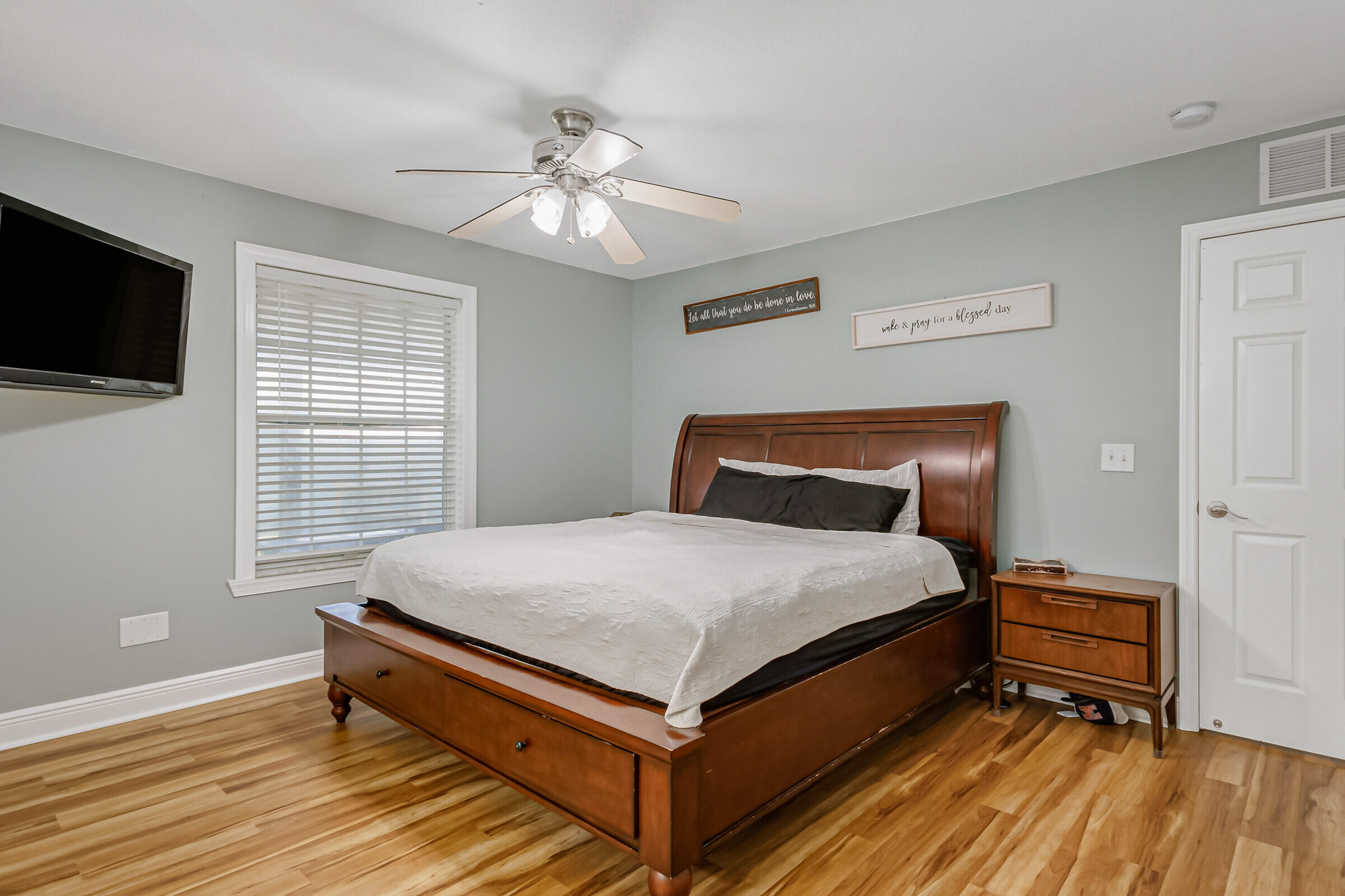 1030 San Rafael Road Southwest Palm Bay, FL 32908 - Photo 7 of 37 a bedroom with a bed and wooden floor