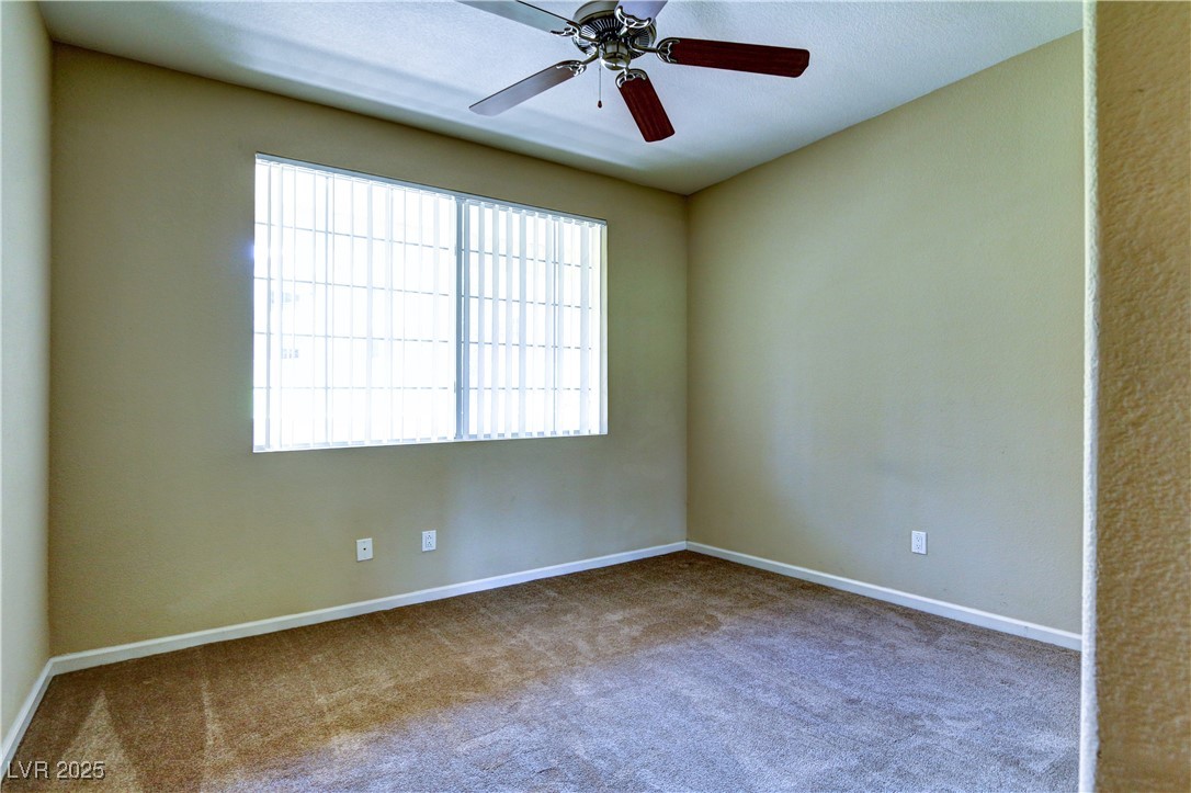 10225 King Henry Avenue, Unit 104 Las Vegas, NV 89144 - Photo 15 of 24 Spare room with carpet flooring and ceiling fan