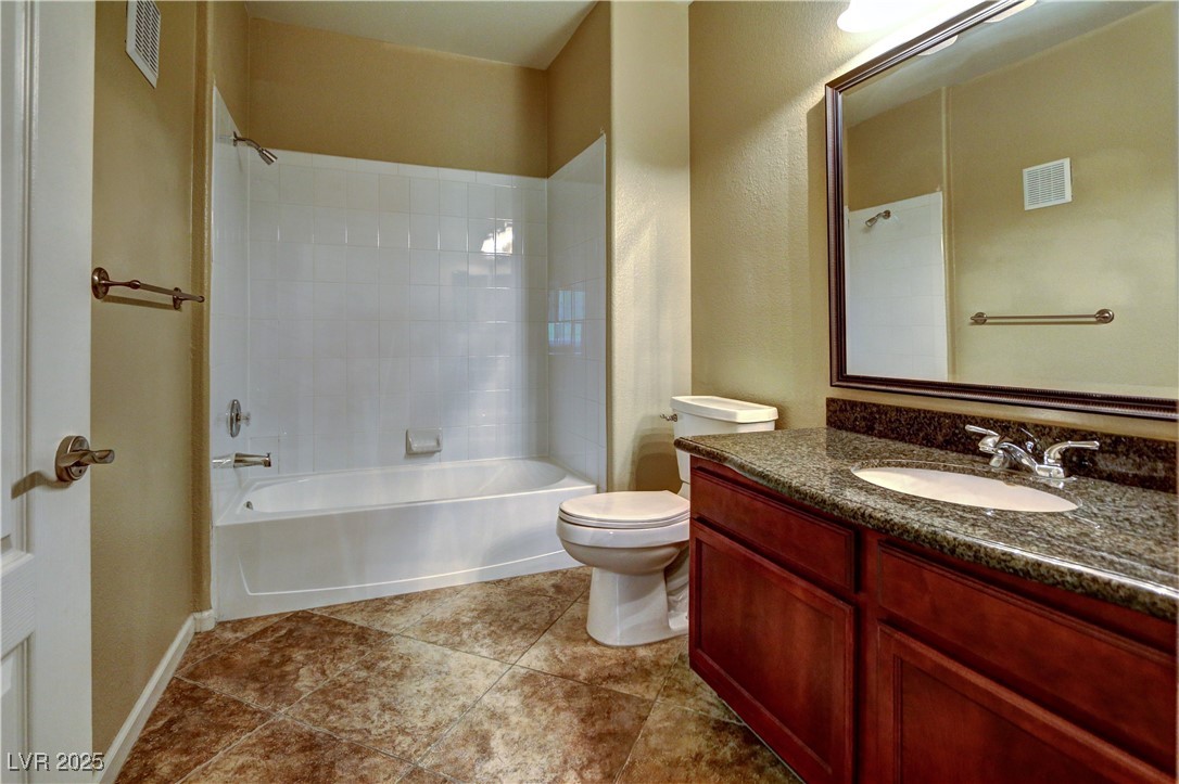 10225 King Henry Avenue, Unit 104 Las Vegas, NV 89144 - Photo 16 of 24 Bathroom featuring tub / shower combination, vanity, and light tile patterned flooring