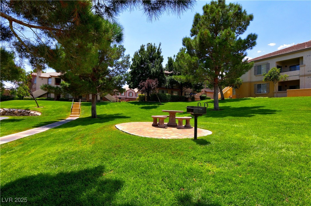 10225 King Henry Avenue, Unit 104 Las Vegas, NV 89144 - Photo 22 of 24 Surrounding community featuring a patio area and a lawn