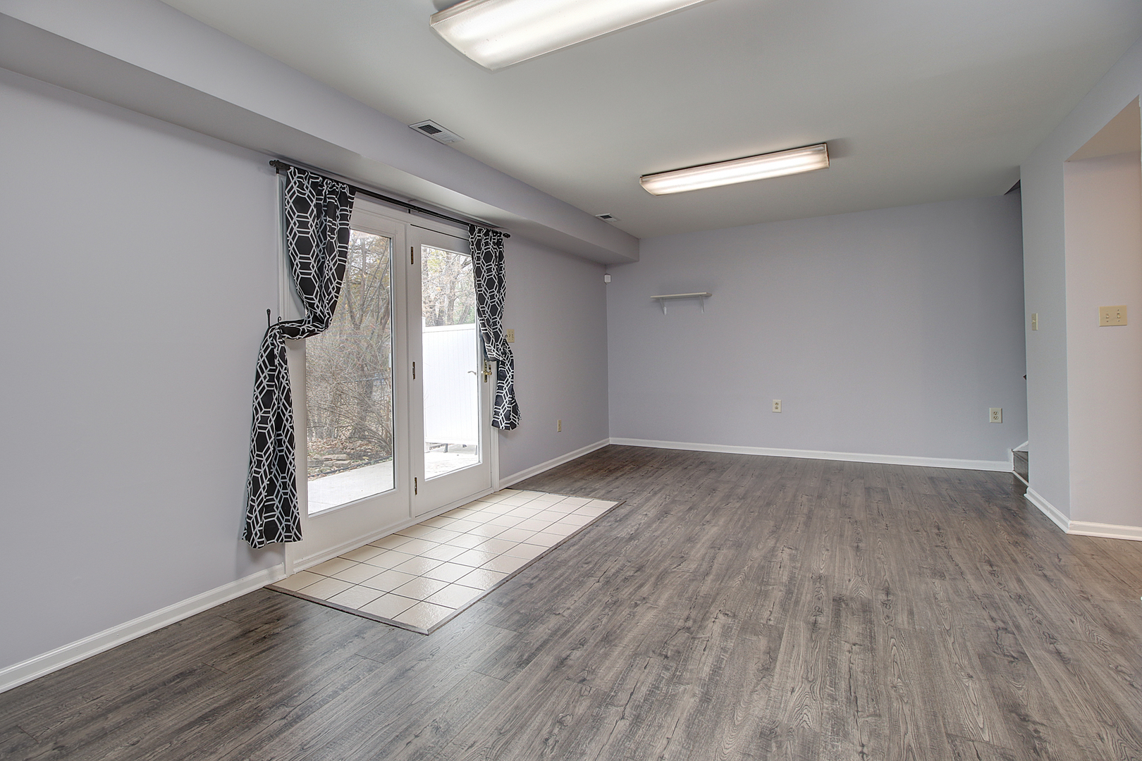 24218 West Main Street Plainfield, IL 60544 - Photo 11 of 19 an empty room with wooden floor and windows