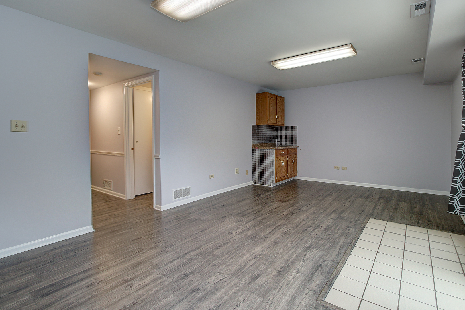 24218 West Main Street Plainfield, IL 60544 - Photo 12 of 19 an empty room with wooden floor and windows