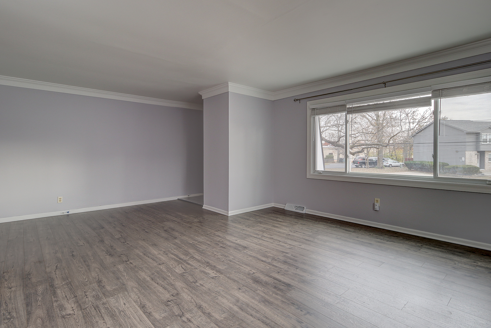 24218 West Main Street Plainfield, IL 60544 - Photo 3 of 19 a view of an empty room with wooden floor and a window