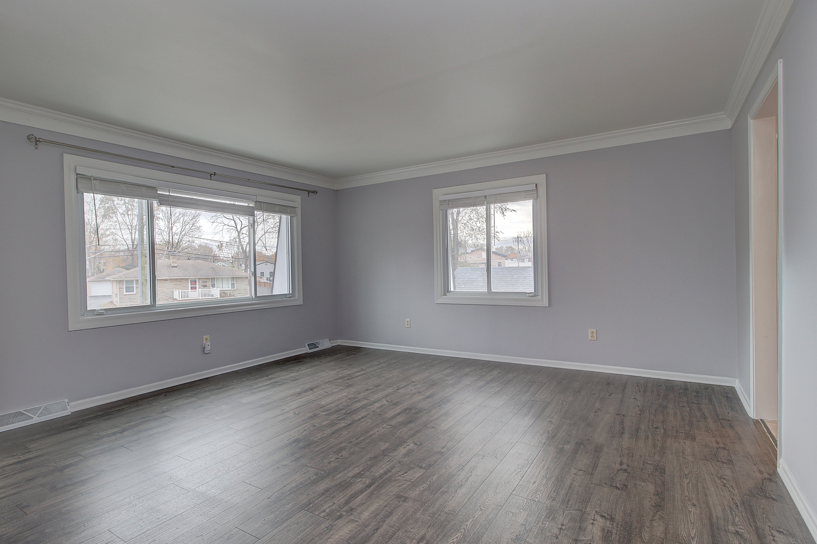 24218 West Main Street Plainfield, IL 60544 - Photo 4 of 19 a view of an empty room with wooden floor and a window