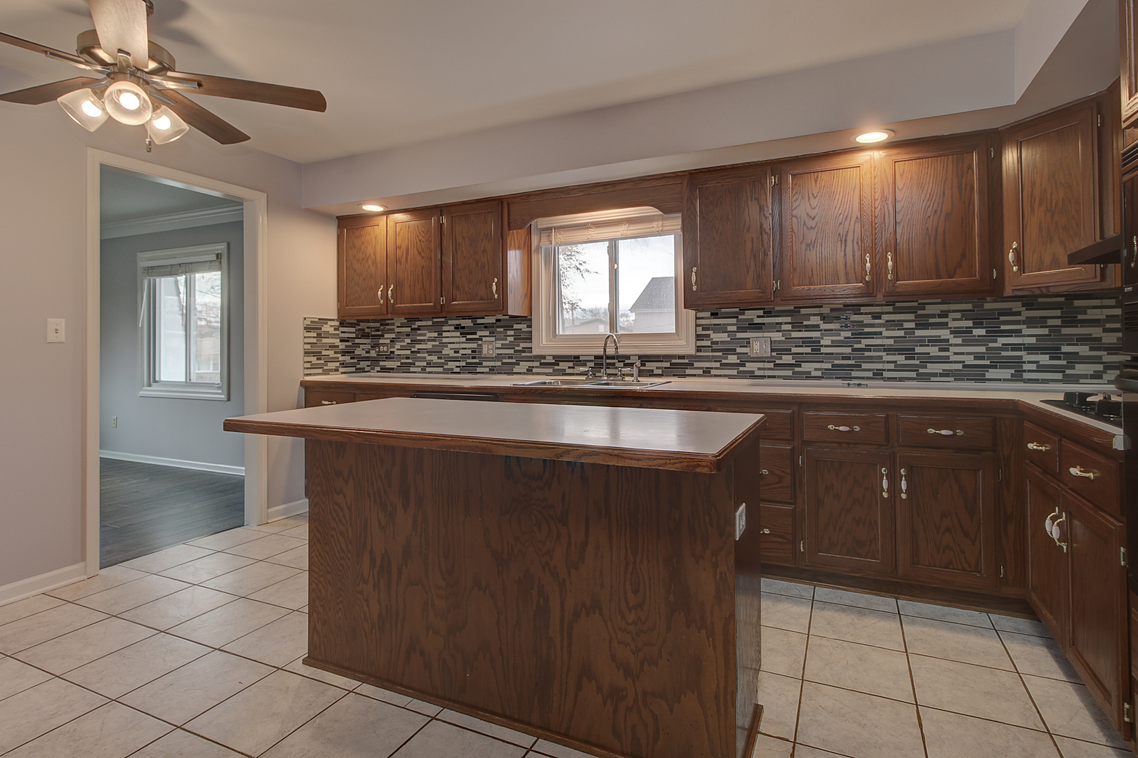 24218 West Main Street Plainfield, IL 60544 - Photo 6 of 19 a kitchen with kitchen island granite countertop a refrigerator and a sink