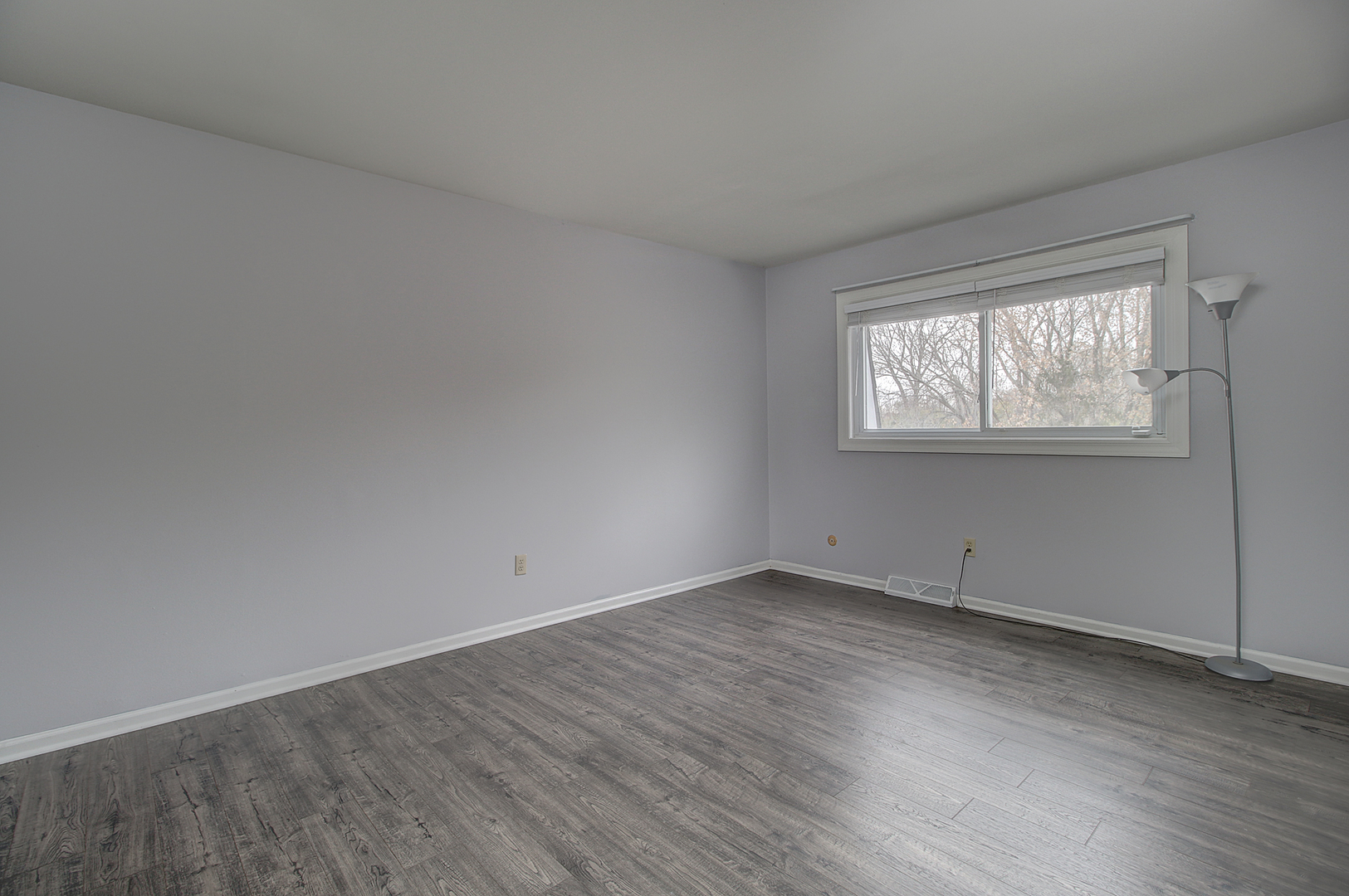 24218 West Main Street Plainfield, IL 60544 - Photo 8 of 19 an empty room with wooden floor and windows