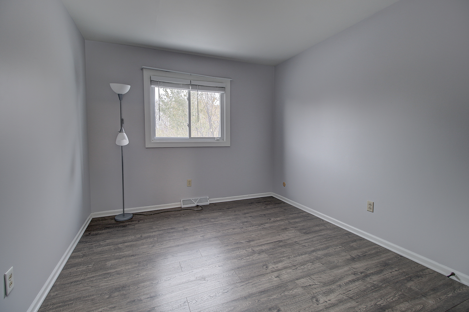 24218 West Main Street Plainfield, IL 60544 - Photo 9 of 19 an empty room with wooden floor and windows