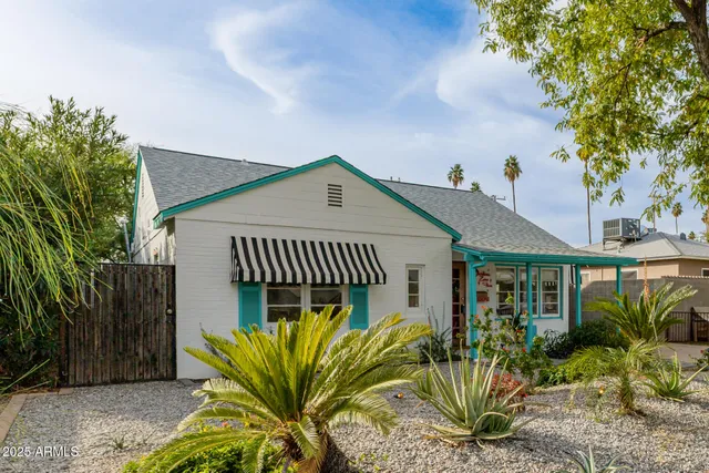 a view of a house with a small yard and plants