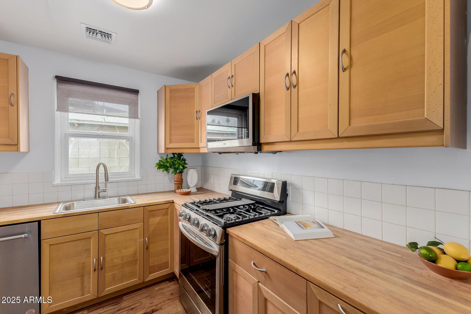 1305 East Granada Road Phoenix, AZ 85006 - Photo 11 of 35 a kitchen with stainless steel appliances granite countertop a sink stove and cabinets
