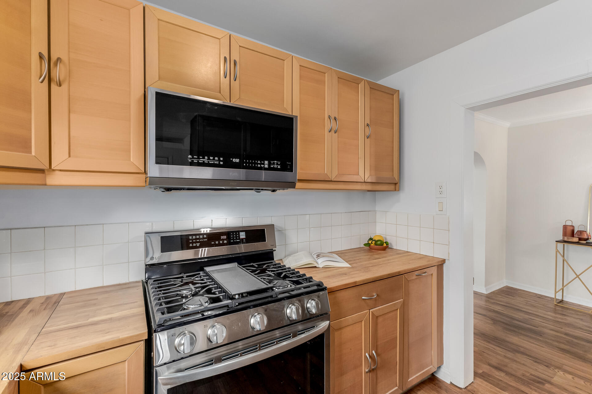 1305 East Granada Road Phoenix, AZ 85006 - Photo 13 of 35 a kitchen with stainless steel appliances granite countertop a stove and a microwave