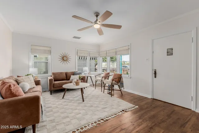 a living room with a flat screen tv and a potted plant