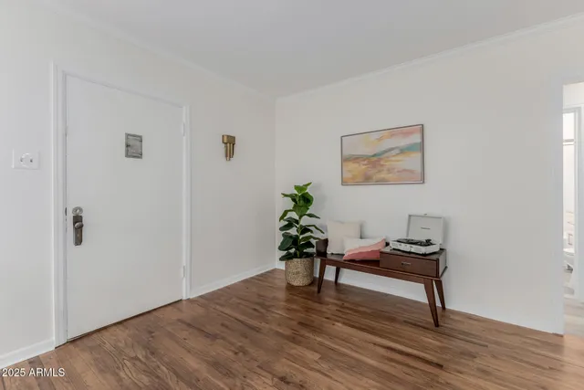 a living room with furniture and a view of kitchen