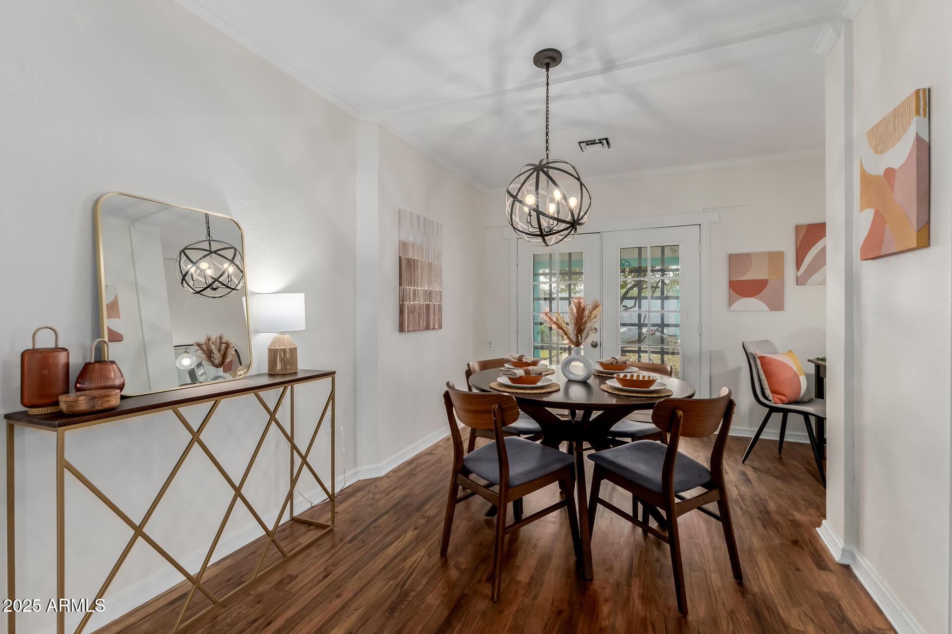 1305 East Granada Road Phoenix, AZ 85006 - Photo 8 of 35 a view of a dining room and livingroom with furniture wooden floor a chandelier