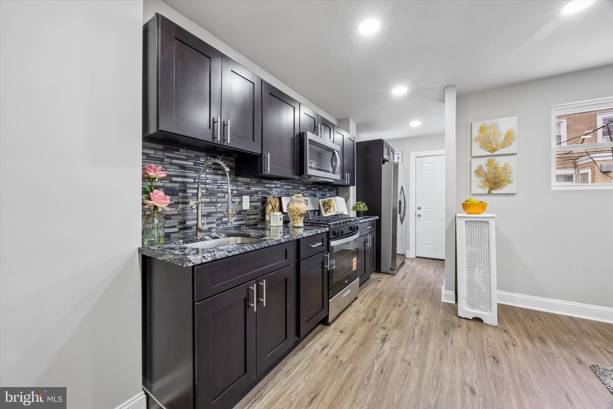 519 Littlecroft Road Upper Darby, PA 19082 - Photo 2 of 12 a kitchen with stainless steel appliances granite countertop a stove a sink and a refrigerator