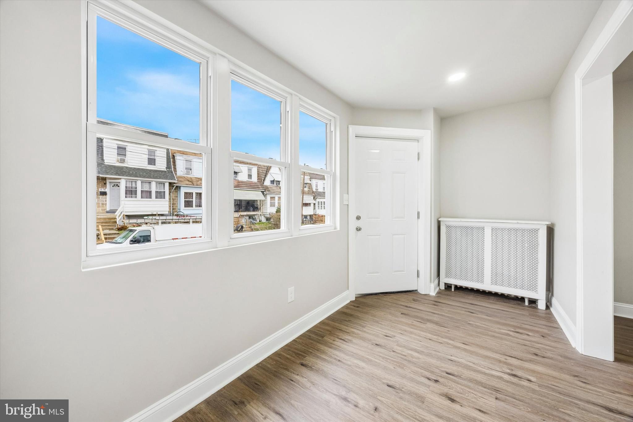 519 Littlecroft Road Upper Darby, PA 19082 - Photo 7 of 12 a view of an empty room with wooden floor and a window