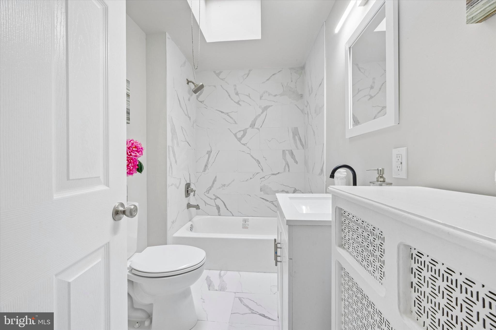 519 Littlecroft Road Upper Darby, PA 19082 - Photo 8 of 12 a bathroom with a sink a toilet and shower