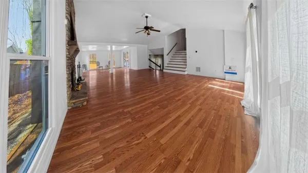 wooden floor in an empty room with a window