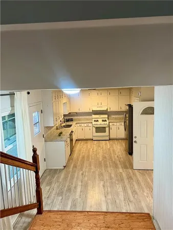 a view of a living room and kitchen area