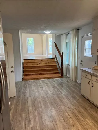 a view of a room with wooden floor and stairs