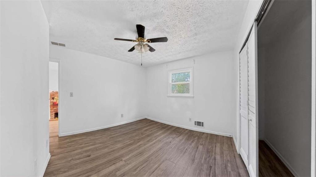 3221 Bromley Rowe Duluth, GA 30096 - Photo 21 of 44 a view of empty room with wooden floor and fan