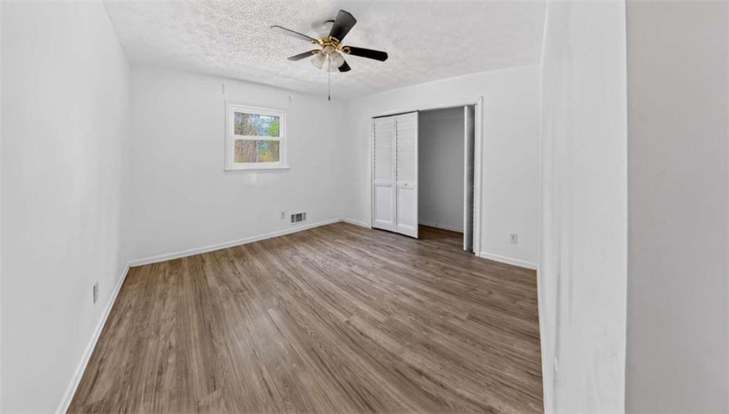 3221 Bromley Rowe Duluth, GA 30096 - Photo 25 of 44 a view of empty room with wooden floor and fan
