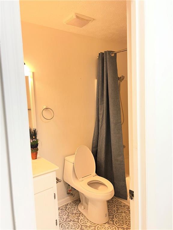 3221 Bromley Rowe Duluth, GA 30096 - Photo 27 of 44 a white toilet sitting next to a bathroom sink