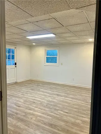 a view of empty room with wooden floor